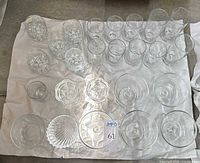 Group view of all 24 glass pieces laid out on white sheet