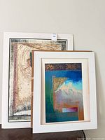 Both framed prints leaning together