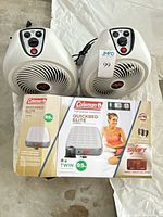 Two white Vornado heaters on top of boxed Coleman Quickbed Elite twin air mattress