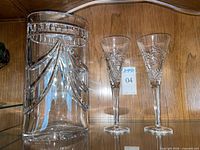 Pitcher and two flutes on shelf