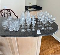 All 30 pieces of cut crystal drinkware on countertop