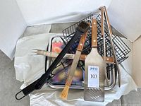 Overall lot showing utensils, baskets, drip pan and cookbook