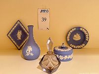 Group shot of all five items: vase, box with lid, square dish, round plate, glass perfume bottle