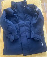 Front view of navy Reima kids parka showing overall design