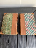 Both law books front covers showing marbled boards and leather spines
