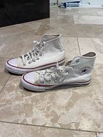 Side profile of both sneakers showing uppers, laces, toe caps and midsoles