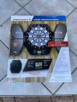 Front of boxed Sportcraft electronic dartboard showing product features