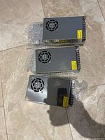 Three of the six Cheng Liang power supplies showing top cooling fans