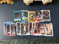 Assorted trading cards laid out on tabletop showing all card fronts