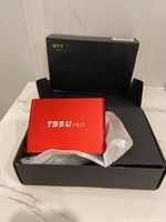 Front view of red T95U Pro unit in open box