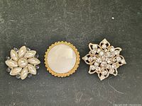 All three brooches front view