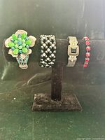All four bracelets displayed on stand