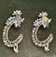 Front view of both earrings showing rhinestone leaf design