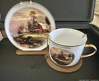 Cup and saucer on wooden base with hanger visible