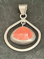 Front view showing coral cabochon and open sterling frame