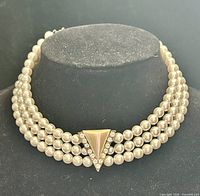Front view of triple-strand faux pearl choker with triangular pendant