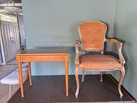 Front view of armchair and table side by side