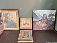 Group shot of four framed artworks on surface