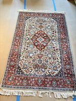 Full view of rug showing pattern, fringe and size reference tape