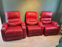 Front view of all three red leather recliners side by side