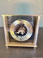 Front view of Seiko world time desk clock displaying dial and case