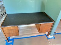 Front view of desk showing drawers and laminate top