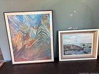 Both framed paintings side by side showing relative sizes and frames