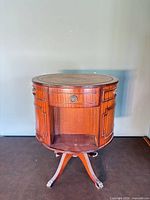 Full front view of drum cabinet showing drawers, shelf, leather top