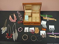 Full lot with jewelry box, necklaces, bracelets, earrings, watches displayed
