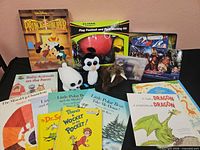 Group shot of all books, toys, plush, flag kit, sealed disc