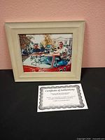 Framed autographed photograph with COA in front