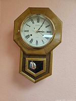 Full view of LeGANT octagon schoolhouse wall clock showing dial and lower door