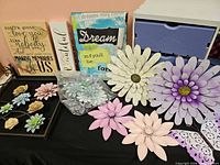 overview of all items on table including metal flowers, signs, drawer unit