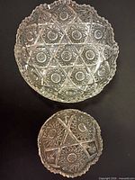 Large and small cut glass bowls top view showing size difference and pattern