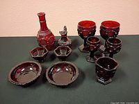 Front view of all ten ruby pressed glass pieces