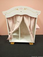 Front view of wardrobe with curtains tied open
