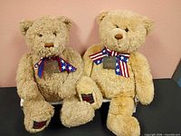 Two tan anniversary teddy bears on shelf