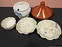 Group shot of all five ceramic pieces on black surface