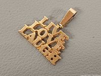 Front view of 10K gold LIVE LOVE LAUGH pendant showing design and mark