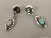 Front view of both earrings showing abalone shell inlays and silver setting