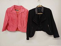 Front view of both blazers hung side by side