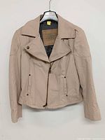 Front view showing asymmetrical zip, lapels, pockets
