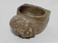 Front angle showing head motif and bowl cavity