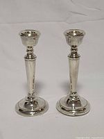 Front view of both sterling candle holders