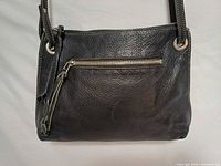 front view showing texture, front zip pocket, hardware