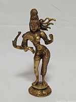 Front view of brass Ardhanarishvara statue showing overall form and detailing