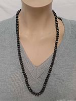 Necklace worn on mannequin to show length and drape
