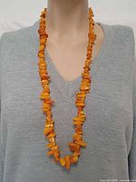 Full view of 32-inch amber chip necklace on mannequin