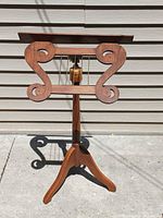 Front view of walnut and brass music stand