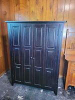 Closed front view of dark stained cabinet